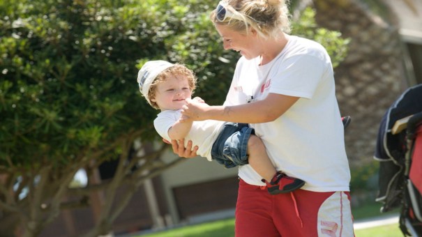 nanny laughing with young child in lakitira