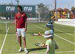 tennis instructor teaching children tennis in levante