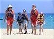 Children on beach in life jackets