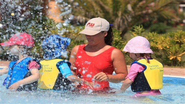 Children in swimming pool with Nanny