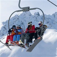 Skiiers and snowboarders on a ski lift