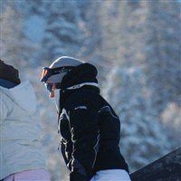 Snowboarders walking up mountain