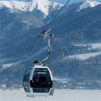 ski lift passing overhead mountain lake