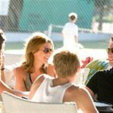 adults chatting at the bar under the sun in lakitir