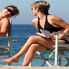 girls chatting and sunbathing on beach in helona