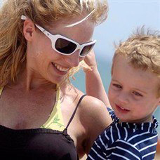 woman smiling with her chiild on the beach in lemnos