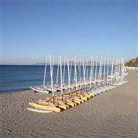 view of beach in helona with sailboats on shore