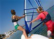 instructor teaching guest how to windsurf in lakitira