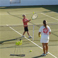 tennis instructor playing a game with a guest in lemnos