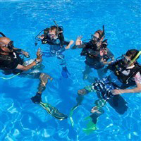 children being taught how to scuba in lakitira by instructor