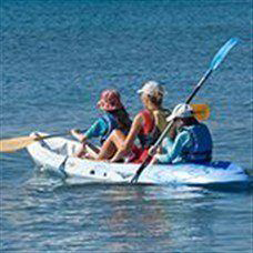 Kayaking trio in the sea.