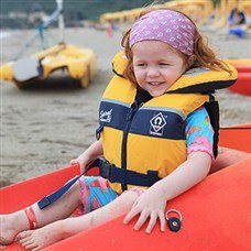 child in boat on beach in perdepera